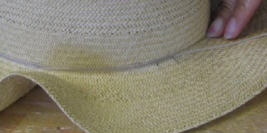 Tie blocked crown of hat with string 